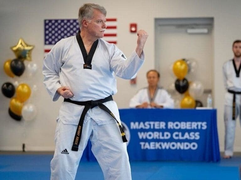 Black belt martial arts master demonstrating traditional taekwondo form