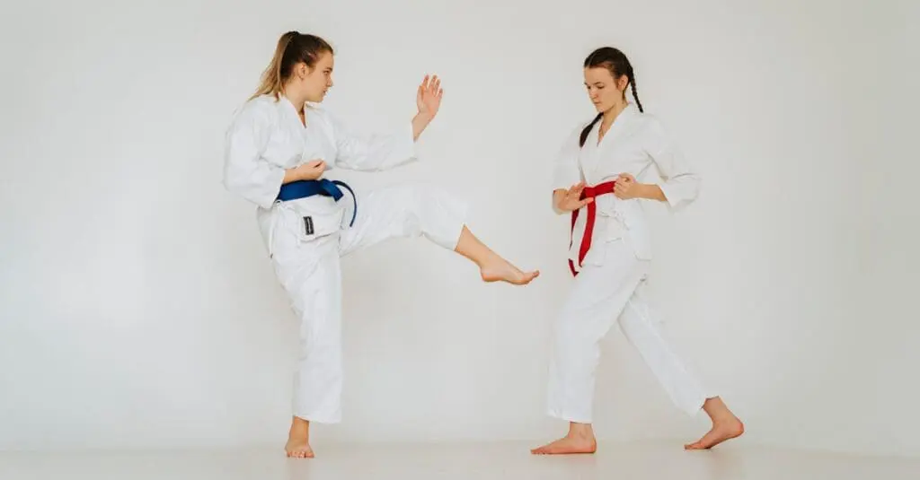 Student practicing a front kick with a partner during beginner karate drills