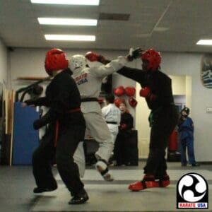 Martial arts students participating in controlled sparring during a dojo session for martial arts training structure.